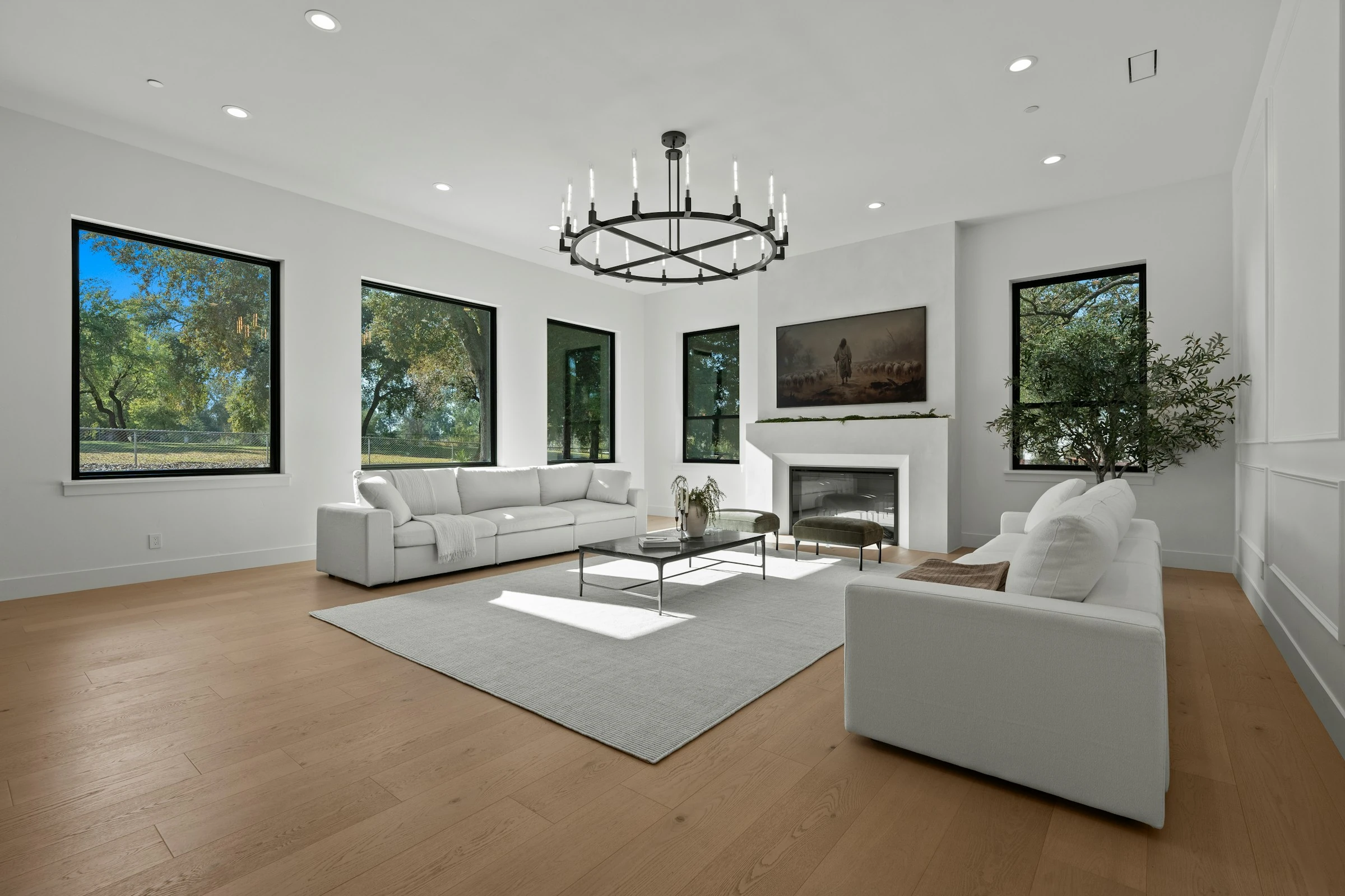 Bright custom living room with natural wood flooring by Artisan Custom Flooring